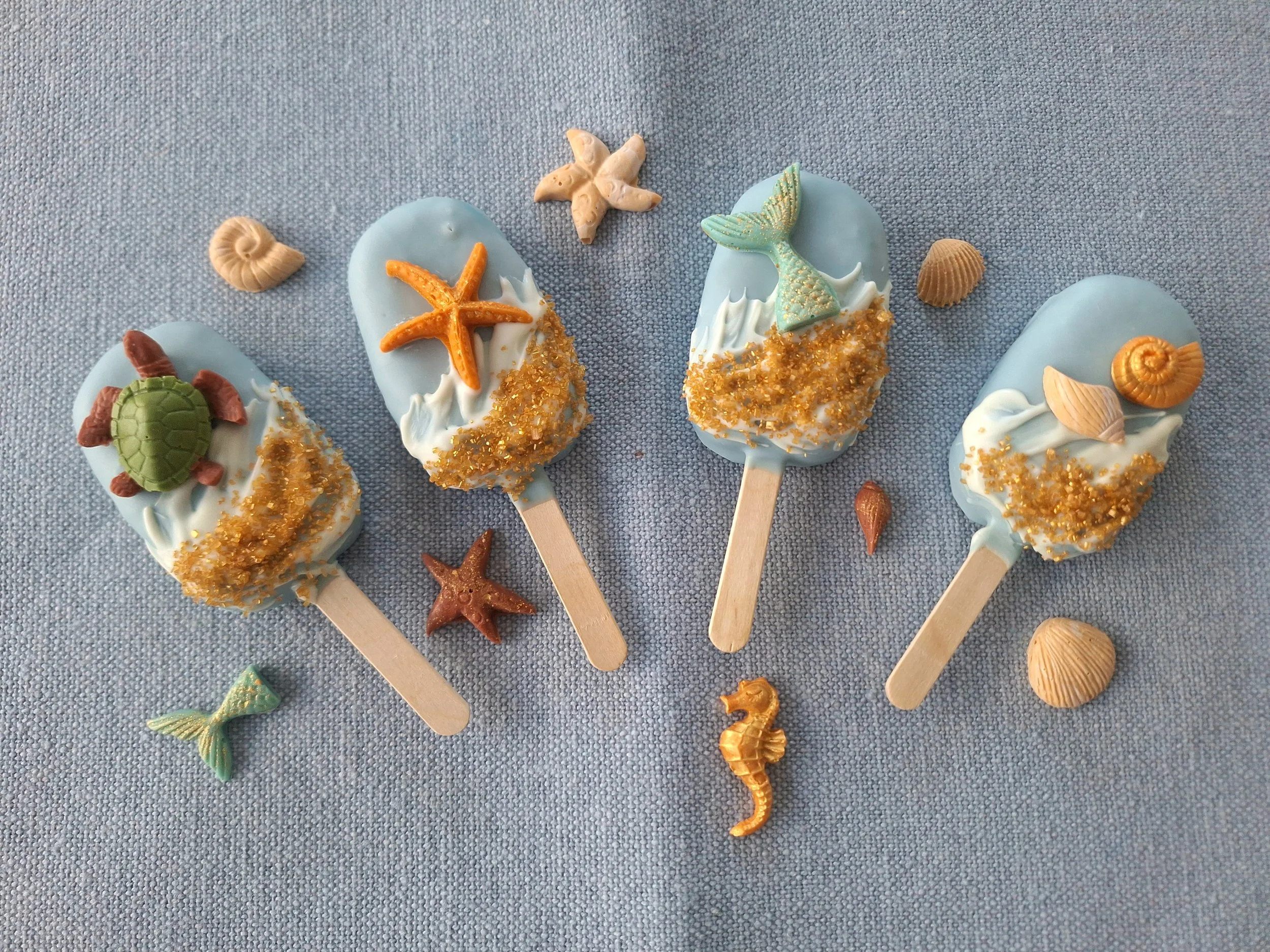 Cakesicles with seashell and starfish decorations